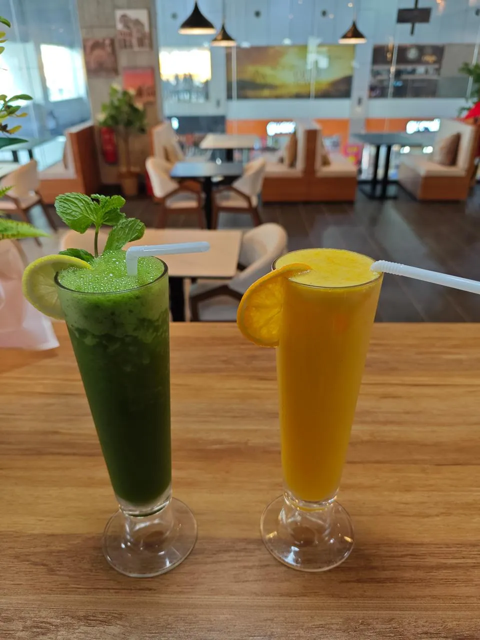 Fresh mint-lemon and orange juices at the counter, dining room behind